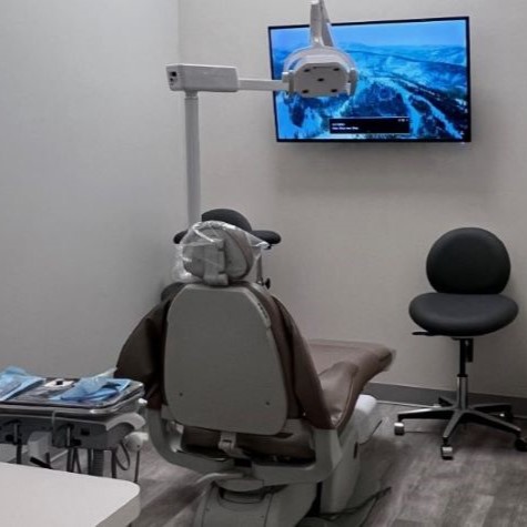 Dental office treatment area with screen on wall