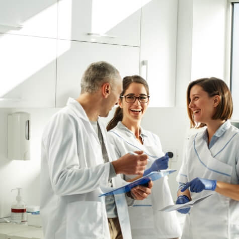 Dental team members smiling and laughing