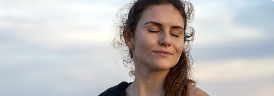 Woman with ponytail with her eyes closed