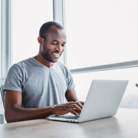 Man sitting at table and working on laptop