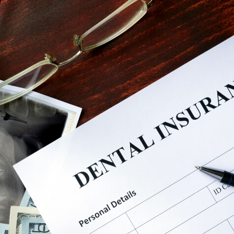 Dental insurance form on a crowded desk