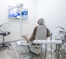 Dental treatment room with TV on wall