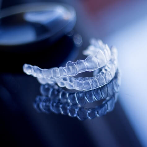 Two Invisalign clear aligners on a counter