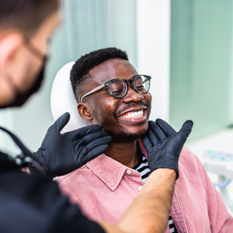 Dentist looking at patient's smile