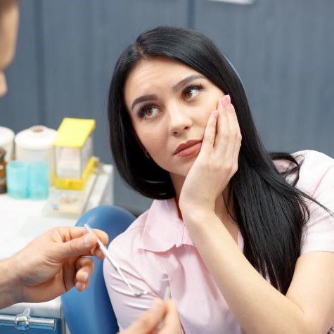 Concerned woman at dental office before root canal treatment in Fulshear